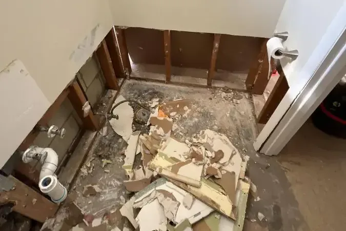 A bathroom stripped to the studs after a sewage backup cleanup
